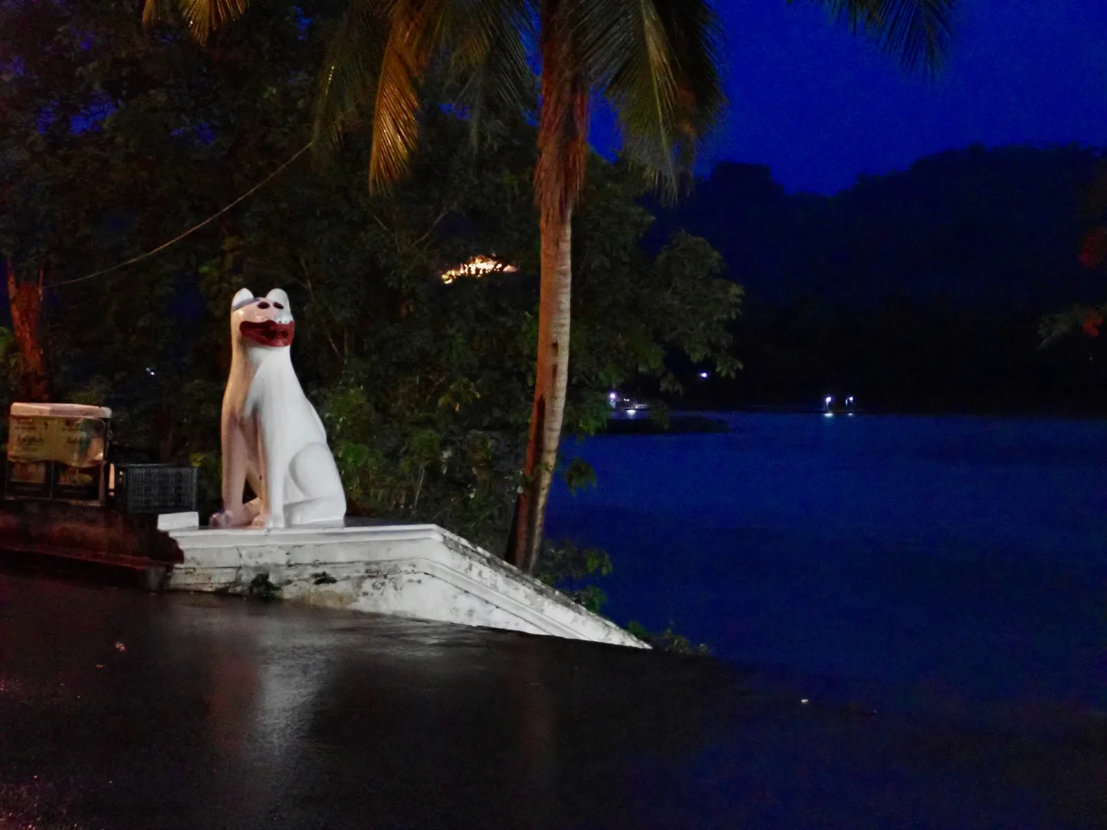 A statue of a dog near the Mekong River at sunrise in Luang Prabang, Laos