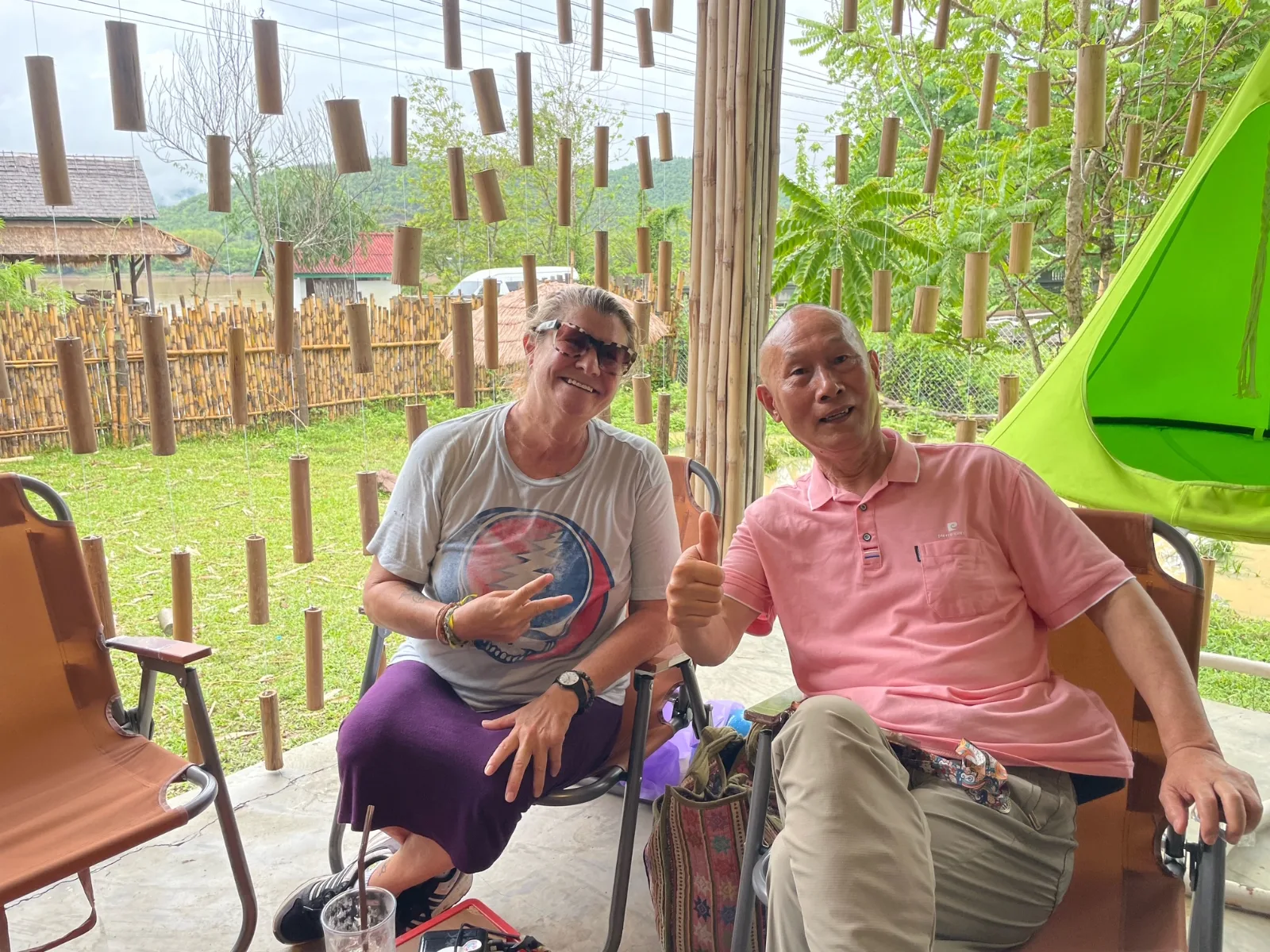A woman with an elderly Chinese man at a coffee stop in Laos